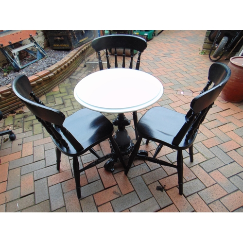 471 - Circular topped pub table, set on on cast iron base, and three rail back chairs.