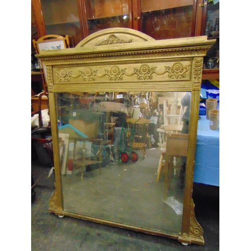 516 - Antique gilt framed over mantle mirror, having arched top and moulded decoration. 58 x 51.