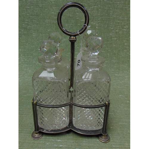 70 - Antique four division plated bottle cruet, having cut glass decanters with stoppers.