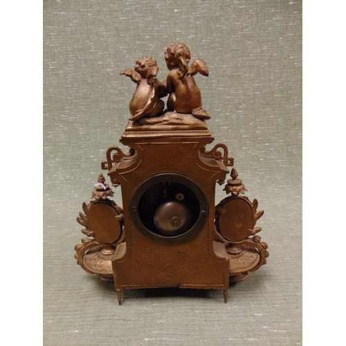 135 - Ornate continental gilt metal painted mantle clock, having figural cherub mount, floral porcelain pa... 