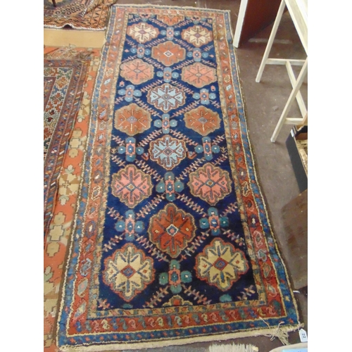 22 - Persian red and blue ground rug, having geometric pattern, 92 x 37