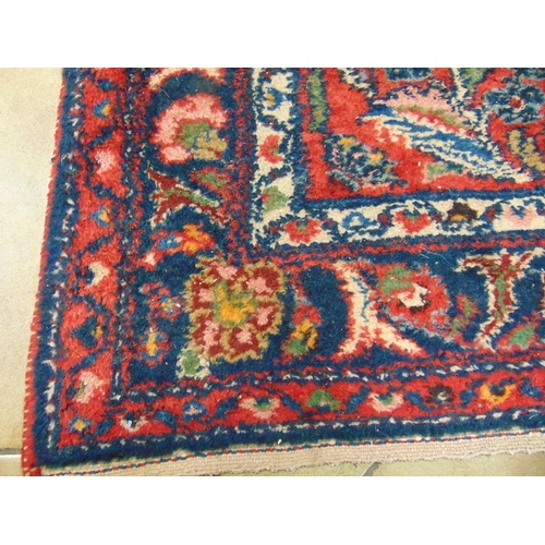 23 - Persian red ground rug, having geometric floral pattern, 77 x 39