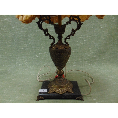 255 - Ornate table lamp and shade, set on faux marble base.