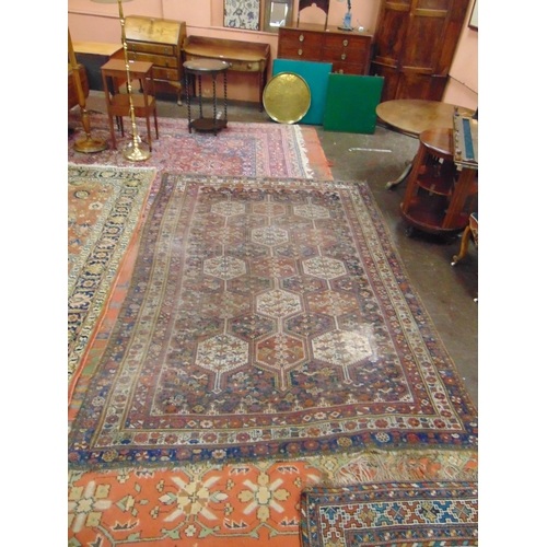 332 - Persian red and blue ground rug, having geometric pattern, for restoration.  112 x 77