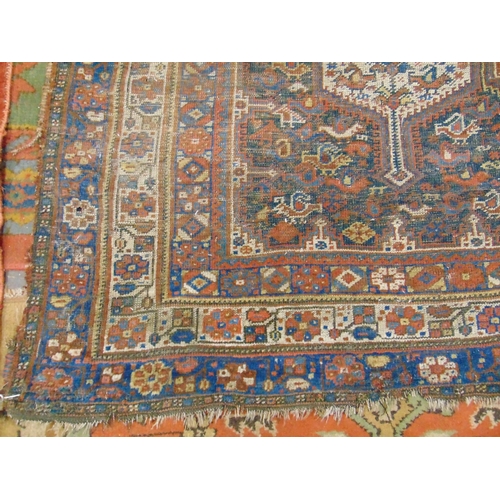 332 - Persian red and blue ground rug, having geometric pattern, for restoration.  112 x 77