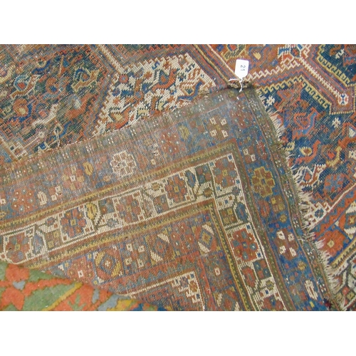 332 - Persian red and blue ground rug, having geometric pattern, for restoration.  112 x 77