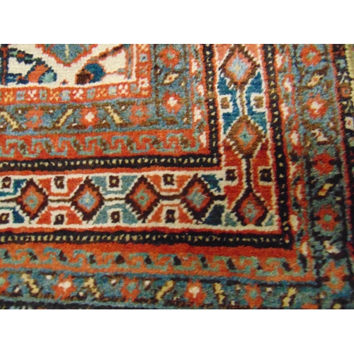 35 - Persian red and blue ground rug, having geometric pattern, 76 x 50