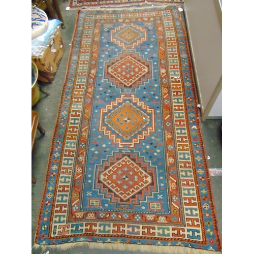 36 - Persian blue and red ground rug, having geometric pattern, 79 x 39