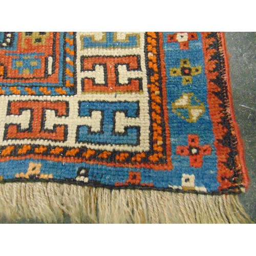 36 - Persian blue and red ground rug, having geometric pattern, 79 x 39