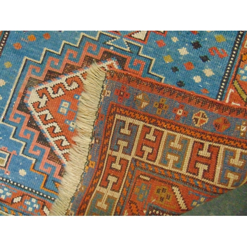 36 - Persian blue and red ground rug, having geometric pattern, 79 x 39