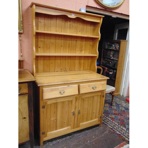 369 - Modern pine dresser, ogive cornice over plate rack back, two short drawers and pair of cupboard door... 