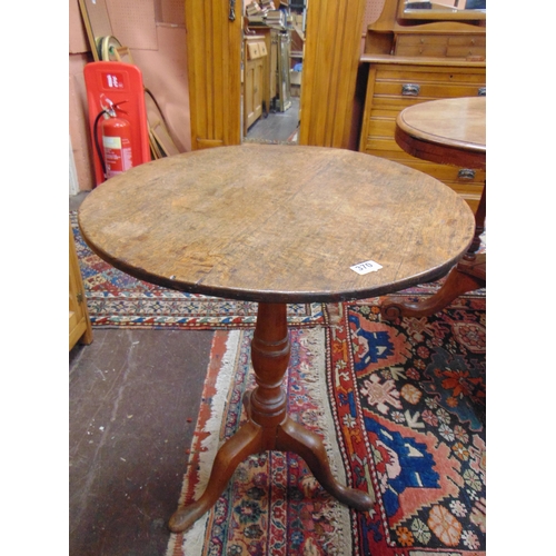 370 - Antique oak tripod table, circular top, gun barrel column and on down swept supports. 28.5