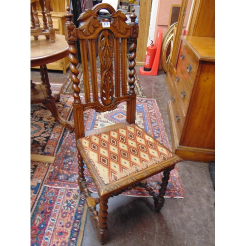 377 - An oak side chair, barley twist columns, upholstered seat.