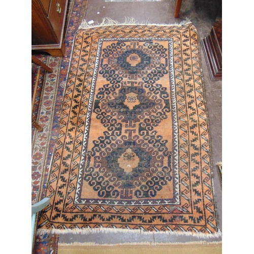 387 - Persian black and orange ground rug, having geometric pattern, 54 x 36