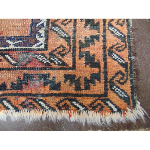 387 - Persian black and orange ground rug, having geometric pattern, 54 x 36