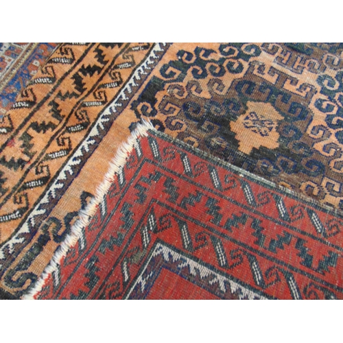 387 - Persian black and orange ground rug, having geometric pattern, 54 x 36