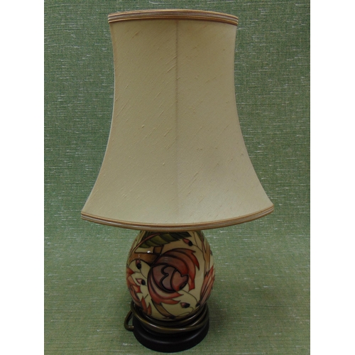 395 - Moorcroft pottery table lamp and shade, having floral decoration. 17