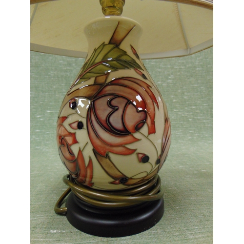 395 - Moorcroft pottery table lamp and shade, having floral decoration. 17