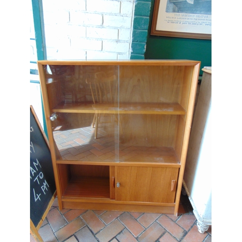 431 - Retro teak bookcase, having pair of glazed sliding doors and further doors to base.