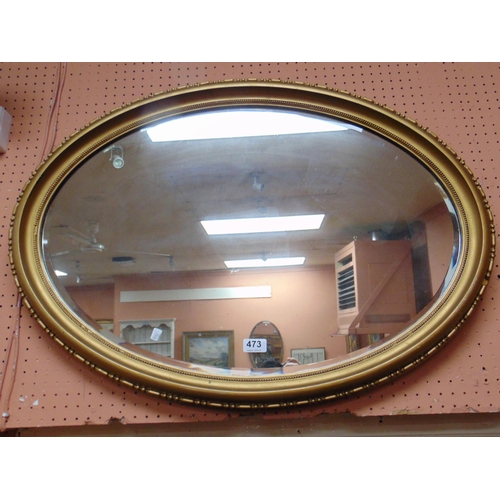 473 - An oval gilt framed bevel edged wall mirror, 31