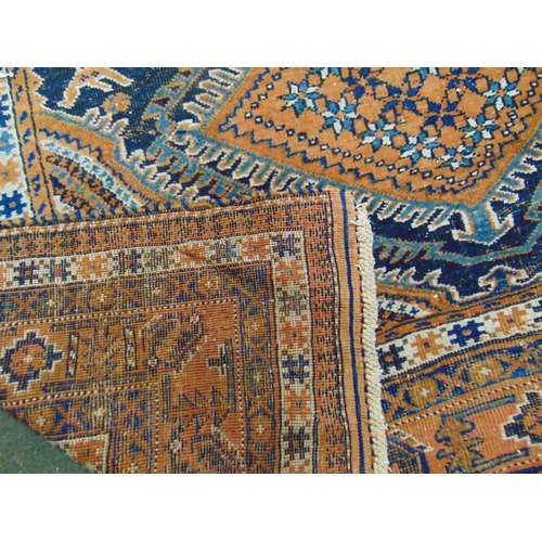 49 - Persian blue and orange ground rug, having geometric pattern. 74 x 58