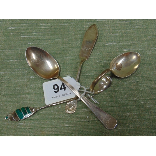 94 - Silver baby feeder, butter knife, spoon and a 958 marked fork.