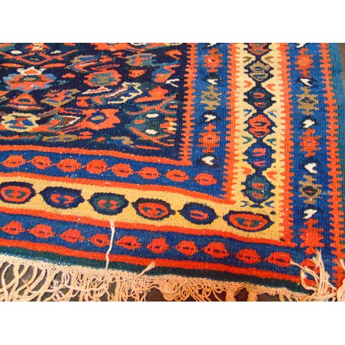 37 - Persian red, blue and yellow ground rug, having geometric pattern, 61 x 42