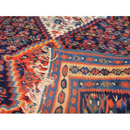 37 - Persian red, blue and yellow ground rug, having geometric pattern, 61 x 42