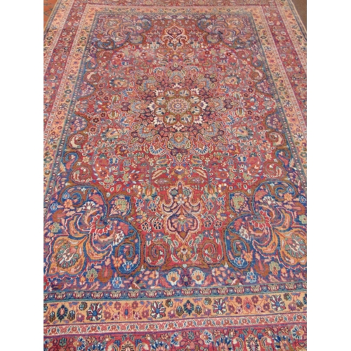 21 - Persian blue, red and pink ground rug,  having geometric floral pattern, 150 x 107