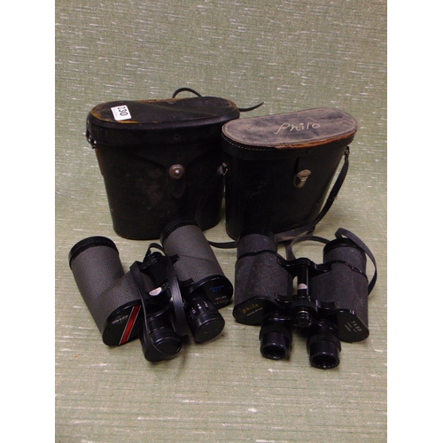 230 - Two cased pairs of binoculars.