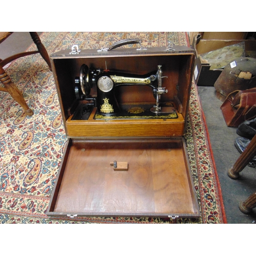 32 - Cased Singer sewing machine and a small suitcase.