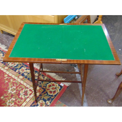 339 - Mahogany card table, fold over top revealing a baize lined interior, on tapered supports.  29