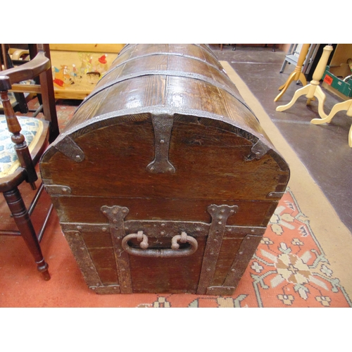 381 - An impressive antique metal bound sea chest, having dome top and side handles,  25 x 57 x 22