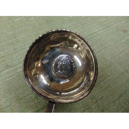 109 - Antique toddy laddel, having George II coin centre and whale bone handle.