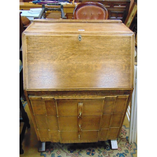 325 - An oak bureau, fall front revealing a fitted interior, over three long drawers and on plain feet. 42... 