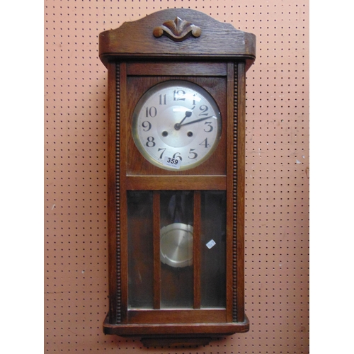 359 - An oak wall clock, silvered dial and Arabic numerals.