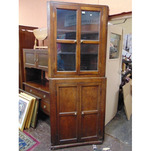 361 - Antique oak corner cupboard, glazed upper section with pair of panel doors to base.  84 x 44