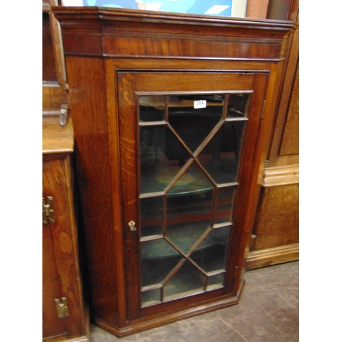 364 - An oak inlaid corner cupboard, ogive cornice, astragal glazed door and shelf lined interior. 47 x 30... 