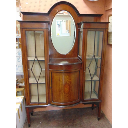 374 - Edwardian inlaid mahogany step top display cabinet, raised back having an oval mirror and bow front ... 