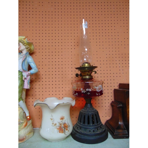 112 - Victorian oil lamp, having clear glass reservoir and cast iron base, 22