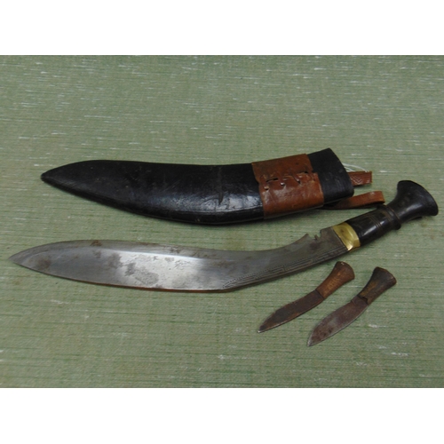 174 - A kukri knife in sheath.