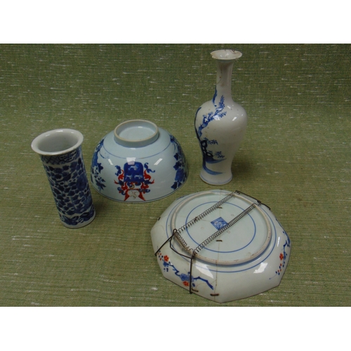 82 - An Oriental vase, decorated with a man standing by a tree, crested blue and white bowl, cylindrical ... 