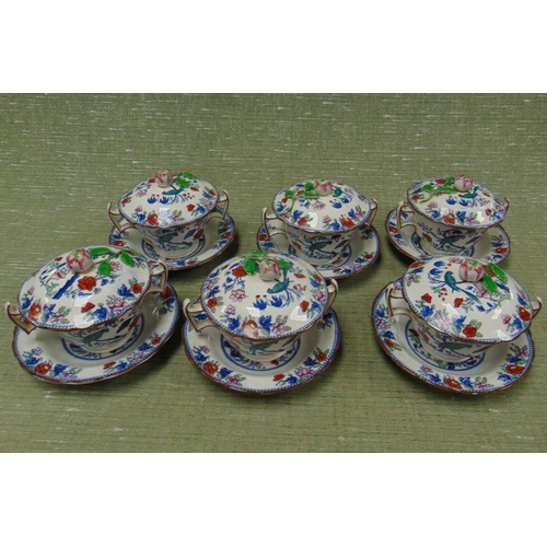 Set of six antique Booths china chocolate cups and covers, set on saucers.