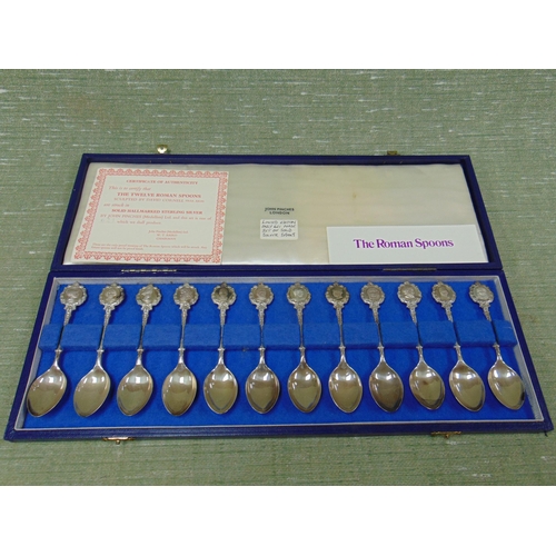 318 - Cased set of silver 12 Roman influenced spoons, maker John Pinches, London, with certificate.