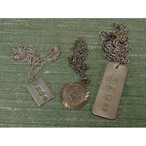 39 - Two silver ingot pendants and a silver St Christopher pendant. (3)