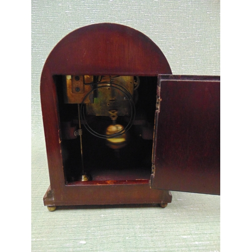 56 - Dome topped mantle clock, having silvered dial and Arabic numerals, 11