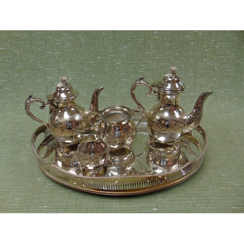 99 - Plated four piece tea service, set on an oval tray.