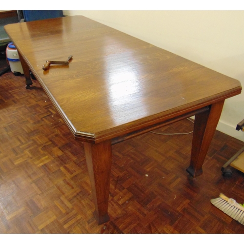 51 - Edwardian oak extending dining table, canted corners, on tapered supports and castors, with two extr... 