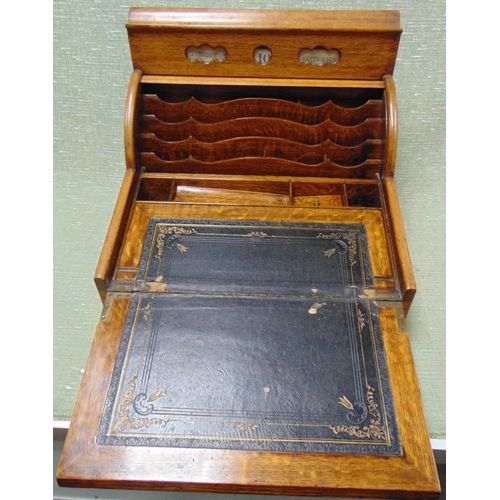 66 - Antique oak writing slope, the top having perpetual calendar, tambour front with pull out leather su... 