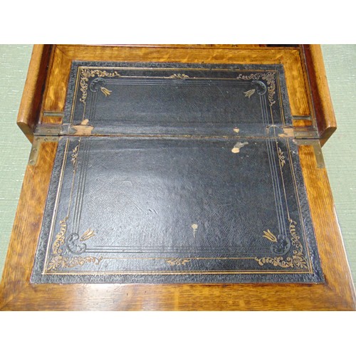 66 - Antique oak writing slope, the top having perpetual calendar, tambour front with pull out leather su... 